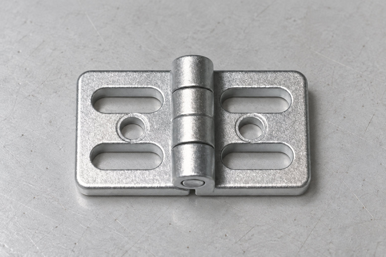 Real zinc hinge close-up showing leaves, barrel, round holes, and slotted mounting holes