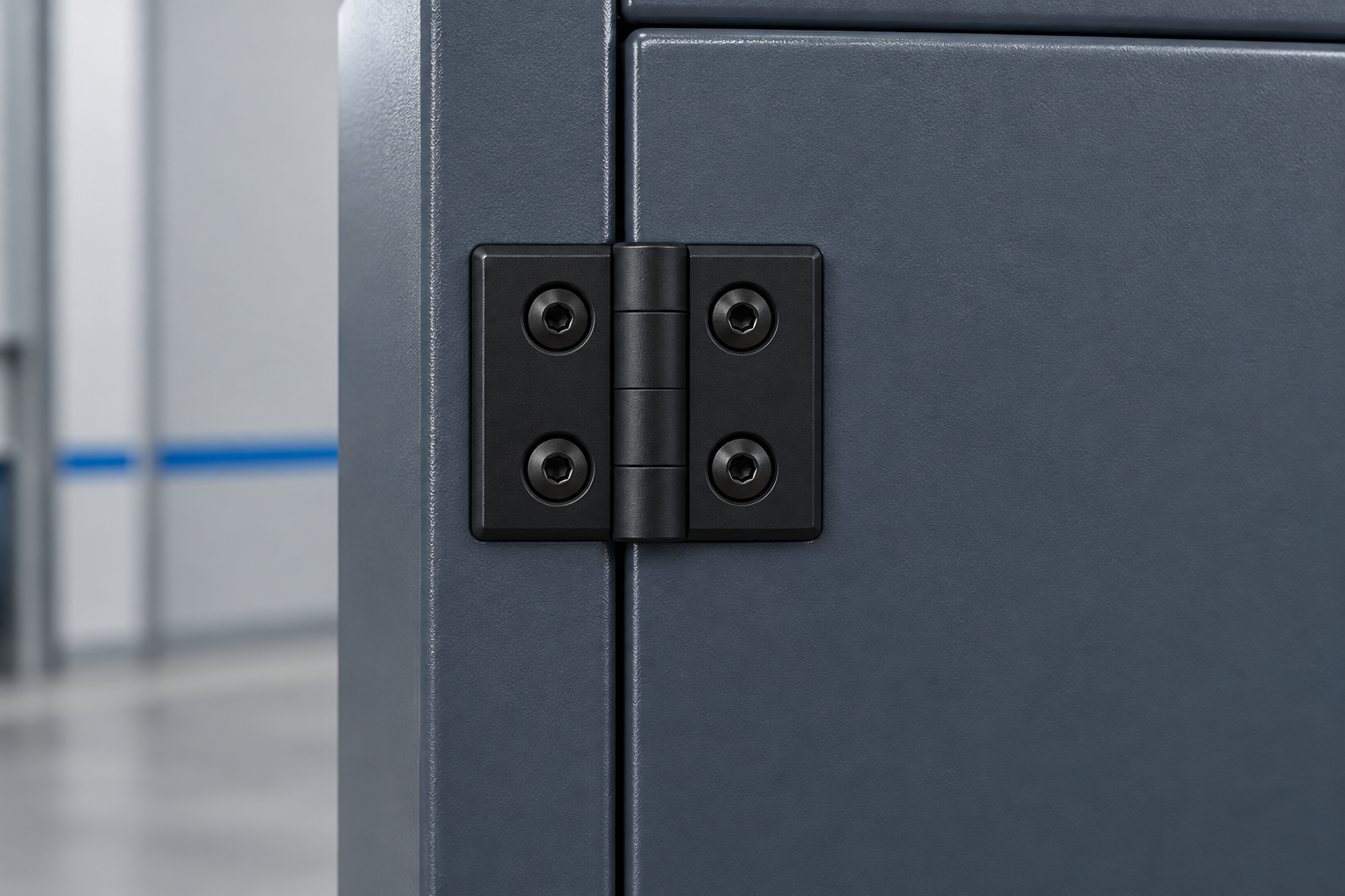 Black plastic Qiyi hinge installed on a dark industrial cabinet door and frame