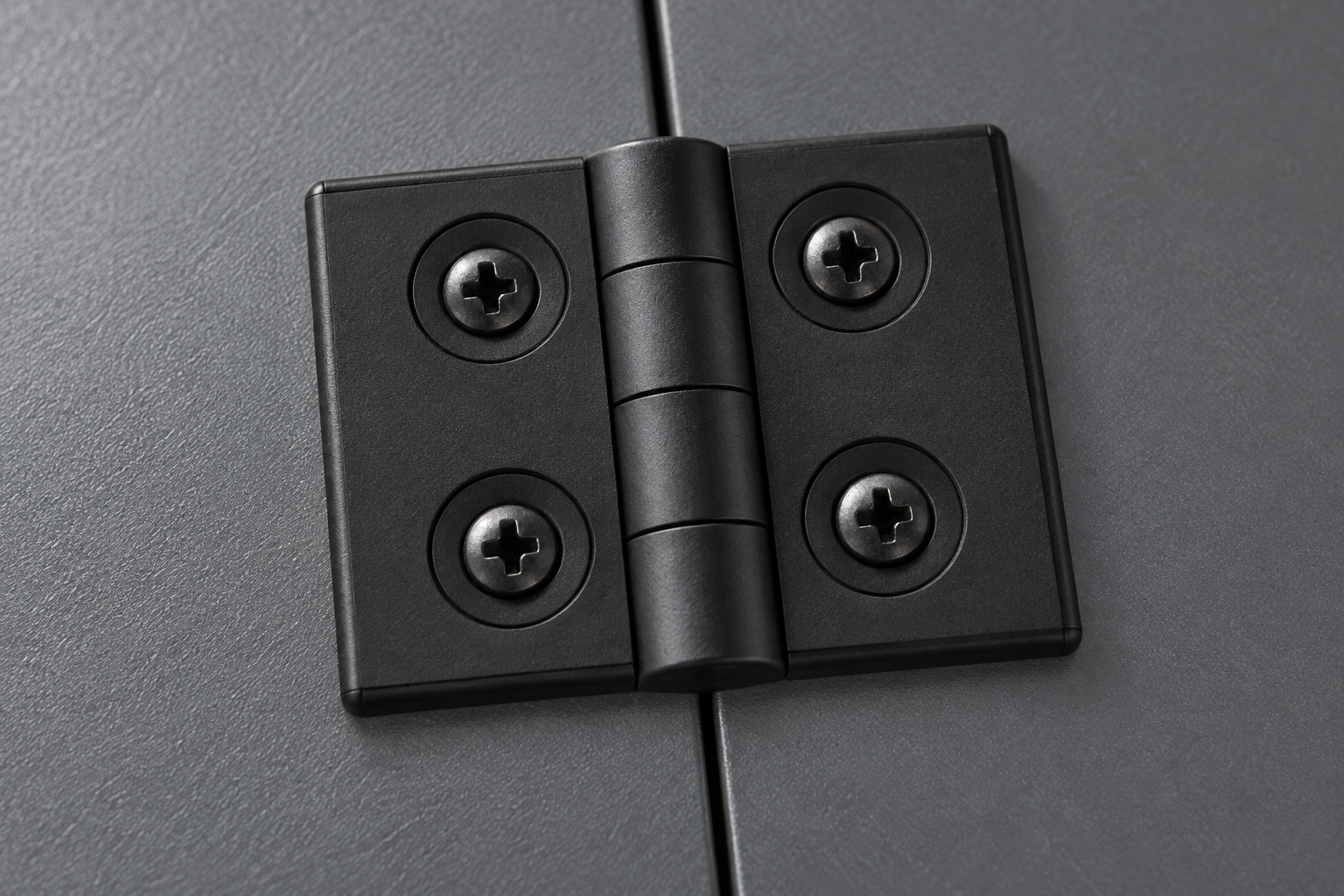 Close-up of a black plastic Qiyi hinge showing leaf geometry and four mounting points