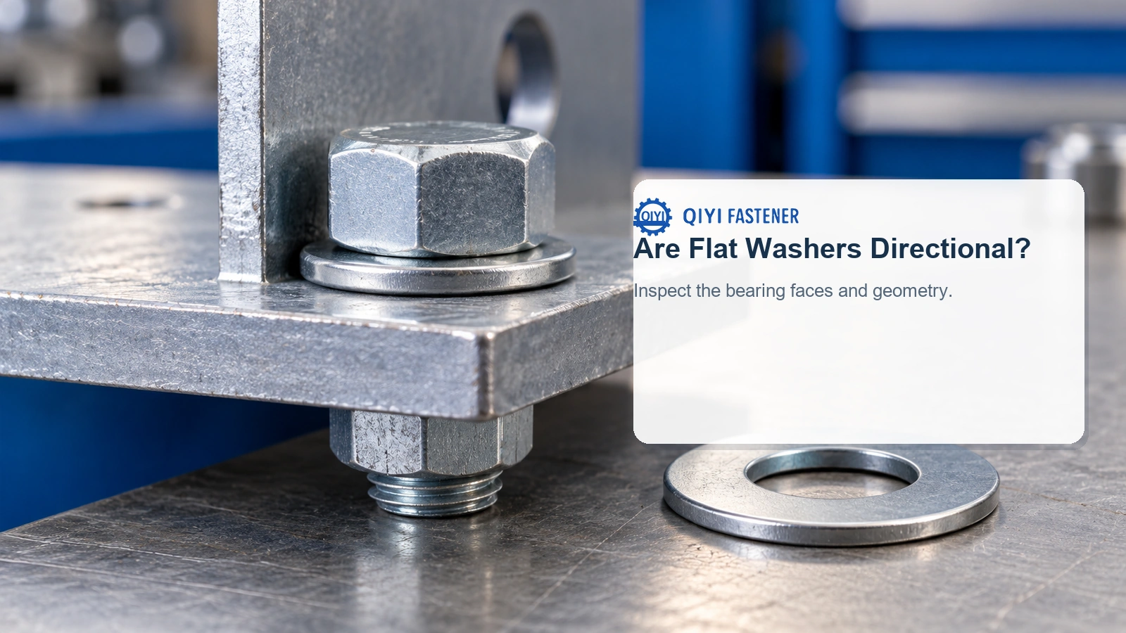 Generic plain flat washers in a supported bracket assembly, showing a seated bearing face and thin edge.